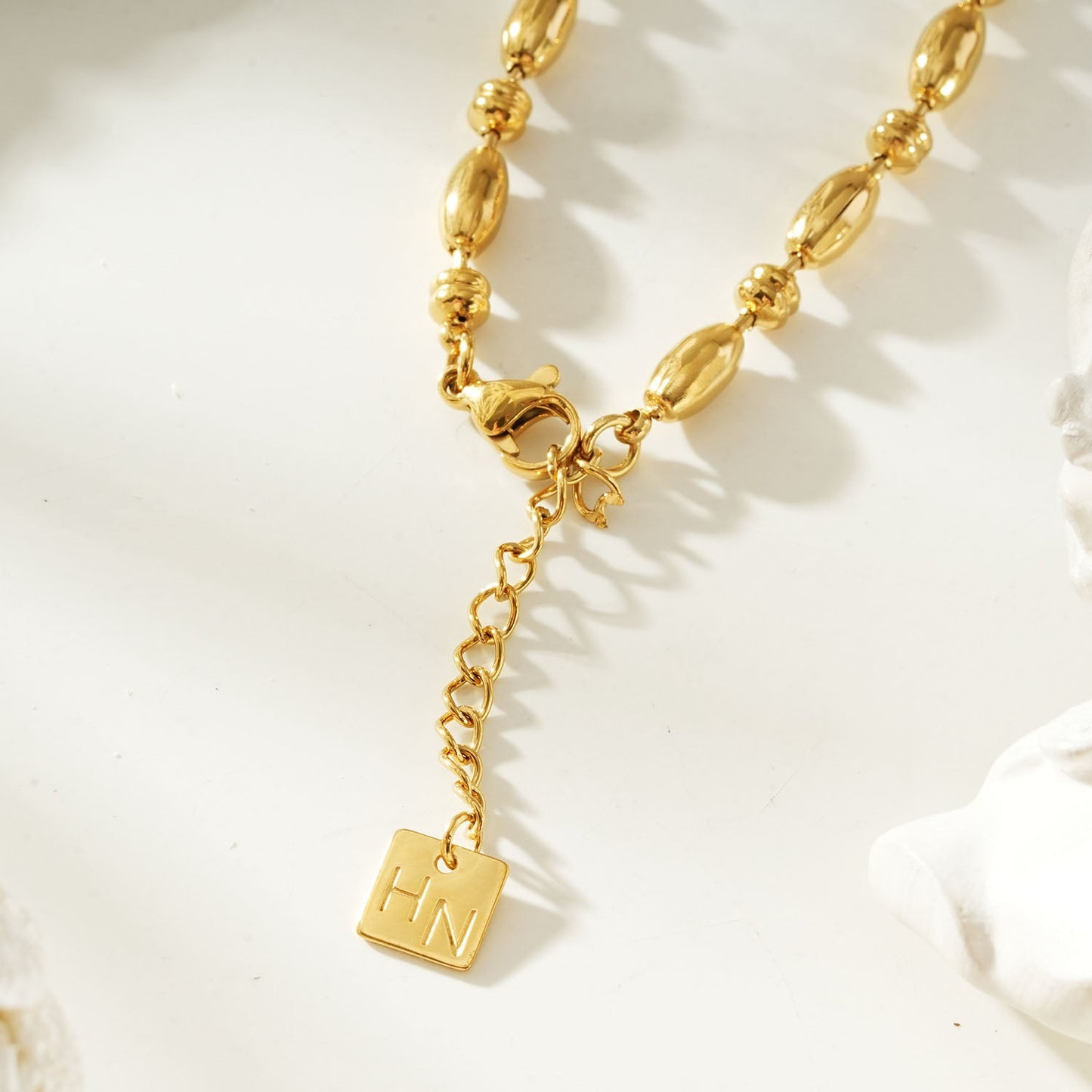 HACKNEY NINE Jewellery ADIATA Gold polished oval bead bracelet featuring sculpted statement design on a clean background.