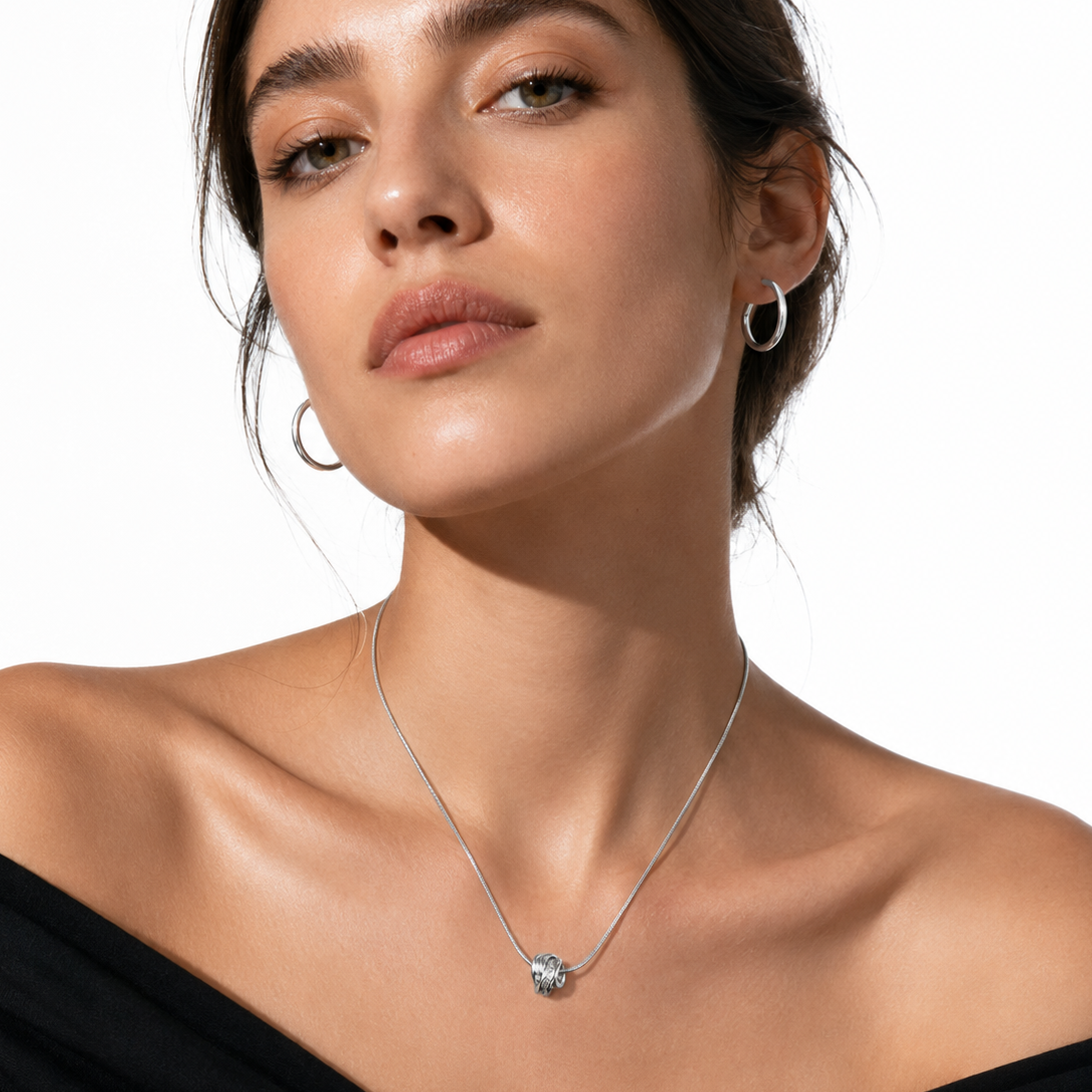Silver knot pendant necklace by Hackney Nine Jewellery featuring a sculptural white gold design.