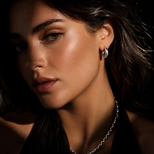 HACKNEY NINE Silver CHOLULA earrings, mid-width smooth surface tube hoop earrings in white gold, shown on a white background.