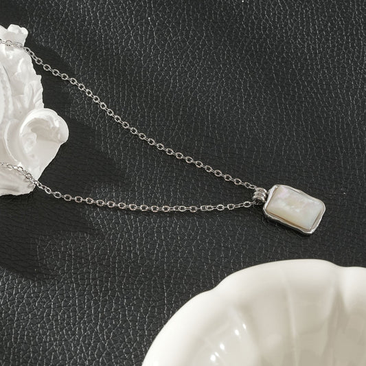 Vintage-inspired silver rectangle shell pendant necklace by Hackney Nine Jewellery, featuring a sleek chain and elegant design.