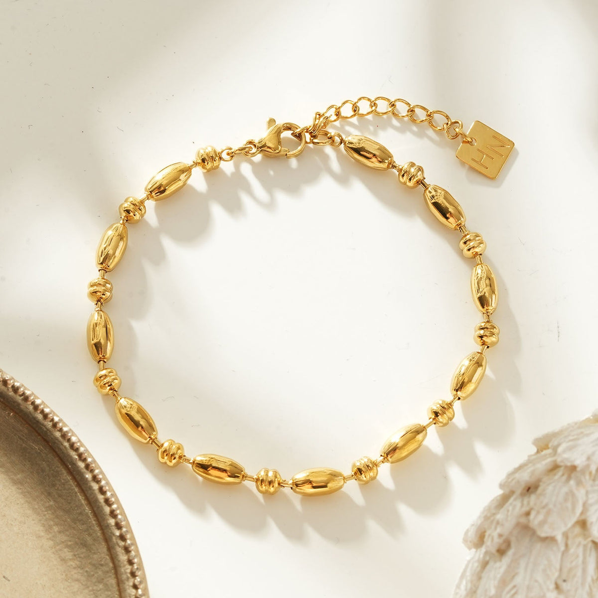 HACKNEY NINE Jewellery ADIATA Gold Polished Oval Bead Bracelet with sculpted design and statement style, close-up view of the bracelet.