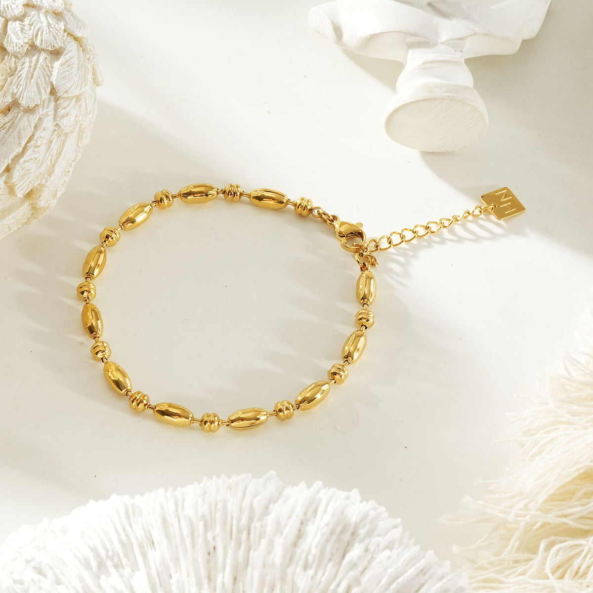 HACKNEY NINE Jewellery ADIATA Gold polished oval bead bracelet with sculpted design, stylish statement jewelry piece.