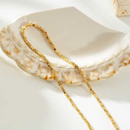 HACKNEY NINE Jewellery RATA Gold Square Beaded Dainty Chain Necklace, close-up view of delicate gold chain with square beads