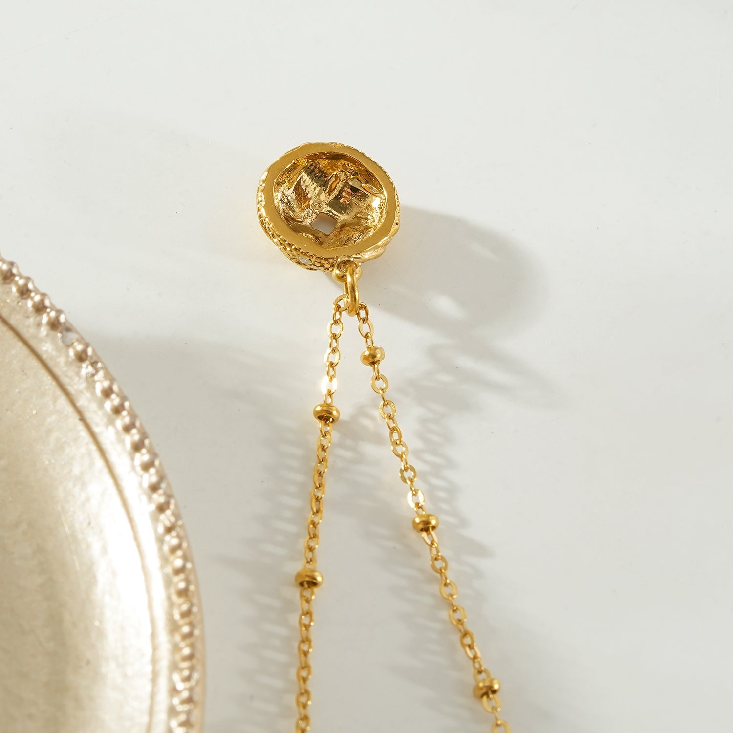 HACKNEY NINE Jewellery SALAMASINA Gold Crystal Interwoven Knot Pendant Necklace showing a gold chain with a crystal-embellished knot pendant.